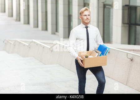 Happiness manager have a new job. Well dressed red hair young adult worker, going to new better work. Outdoor shot in stairs, move up Stock Photo
