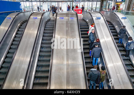 London, UK - August 16, 2017 - Escalators with commuters at North Greenwich underground station Stock Photo