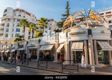 Luxury shops, including Rolex, in the Croisette district of Cannes, Cote d'Azur, France Stock Photo