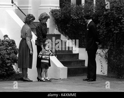 A wave from Prince William, 3, close to his mother Diana, Princess of Wales, watched by Mrs Jane Mynors as the royals arrived at her Victorian terraced home in Notting Hill Gate, London, where she runs a private kindergarten. Stock Photo