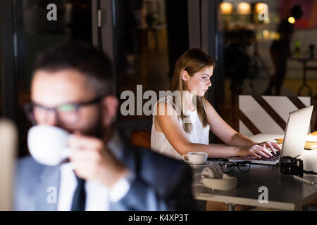 Businesspeople in the office at night working late. Stock Photo