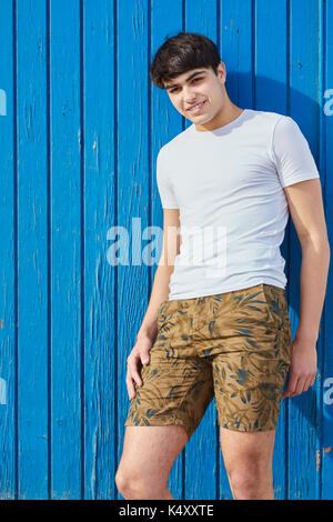 Portrait of young man handsome man standing in laid back pose smiling Stock Photo