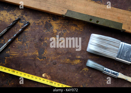 Old spirit level and brushes on textured background Stock Photo