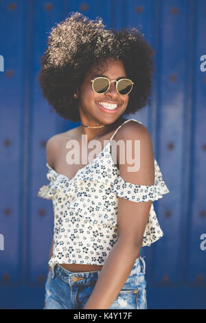 Portrait of young beautiful afro american woman in sunglasses smiling Stock Photo
