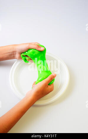 Slime, green pate elastic and vicous on child's hand Stock Photo - Alamy