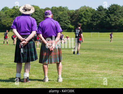 Two Scotsmen / Scottish men wearing kilts watch a rugby match Stock Photo