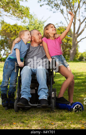 Disabled father doing selfie with children. Stock Photo