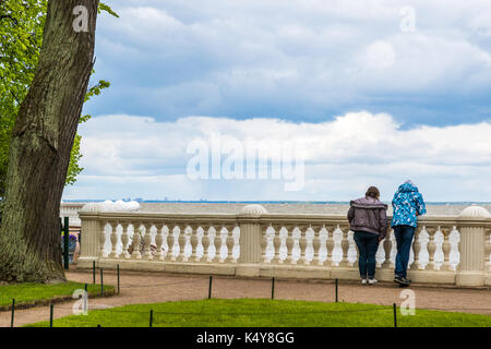 People look at Gulf of Finland from embankment in Peterhof Russia Stock Photo