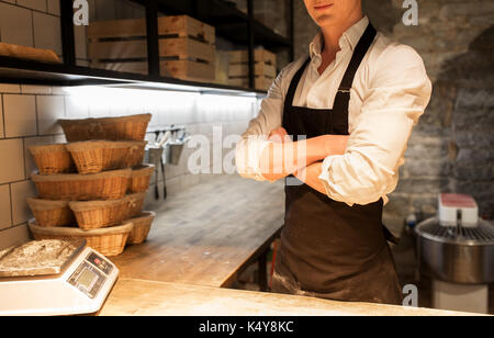 chef or baker in apron at bakery kitchen Stock Photo