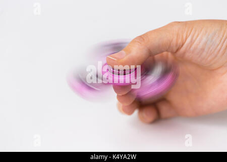 close up of hand playing with fidget spinner Stock Photo
