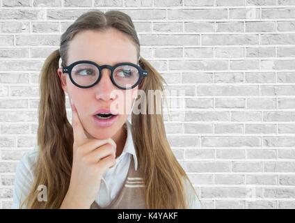 Digital composite of Close up of nerd woman thinking against white brick wall Stock Photo