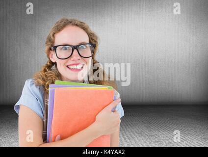 Digital composite of Nerd woman with books in grey room Stock Photo