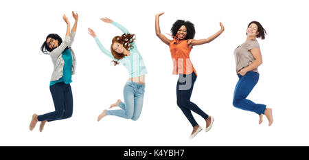 happy women jumping in air over white background Stock Photo