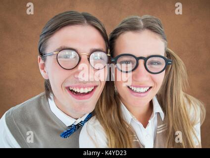 Digital composite of Close up of nerd couple against brown background with grunge overlay Stock Photo