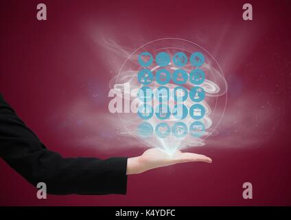 Digital composite of hand with application icons coming up from it. dark red background Stock Photo