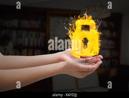 Digital composite of hands with lock fire icon over in the living room. Stock Photo