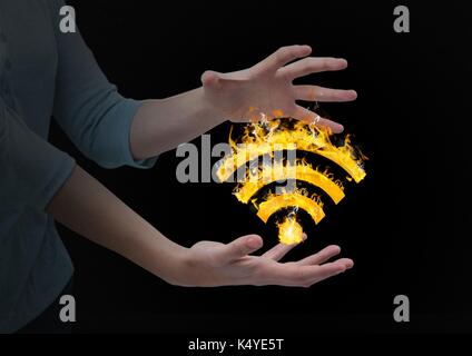 Digital composite of woman hands with WIFI fire icon between. Black background Stock Photo