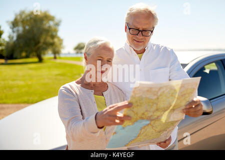 senior couple at car looking for location on map Stock Photo