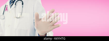 Doctor touching an digital screen  against pink Stock Photo