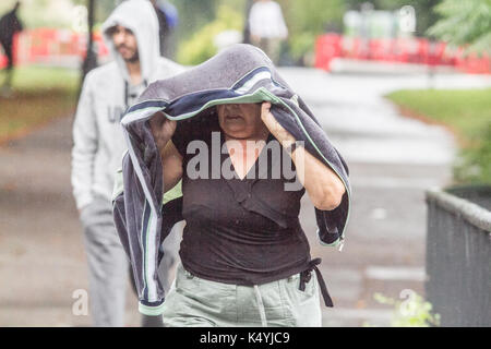 London, UK. 7th Sep, 2017. A woman shelters from the rains in Regents Park as the wet weather arrives in London Credit: amer ghazzal/Alamy Live News Stock Photo