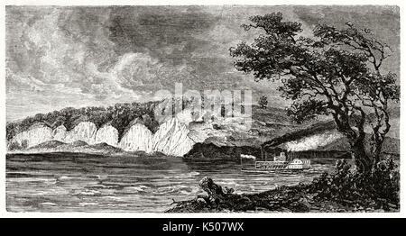 Ancient St Joseph surroundings along Missouri river USA. Steamboat sails the water under a dark stormy sky. By Guaiaud after The Geological Survey of Missouri published on Le Tour du Monde Paris 1862 Stock Photo