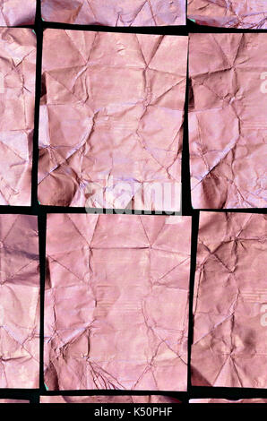 close up of a creased, pink  aluminium foil  texture, full frame, flat lay, cubes pattern, vertical Stock Photo