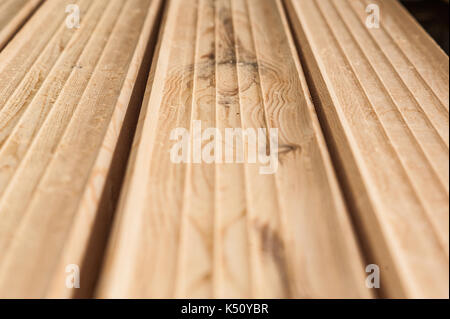 Fresh wooden beam, stacked at construction site. The surface of the processed wooden beam. close Stock Photo
