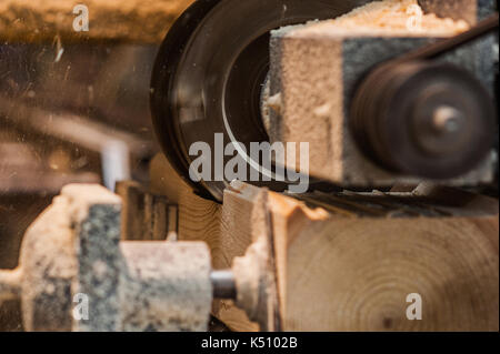 The machine for sampling the groove in a wooden beam. in progress closeup Stock Photo