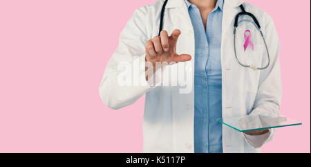 Cropped image of female doctor holding digital tablet while using invisible screen against pink background Stock Photo