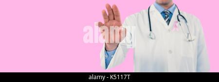 Doctor touching an digital screen  against pink background Stock Photo