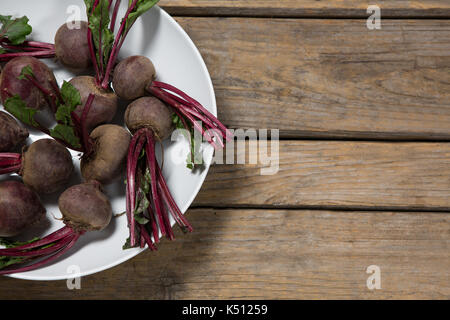Fresh organic beetroots in a bowl on wooden table Stock Photo