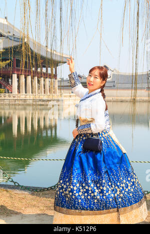 Beautiful Korean woman dressed Hanbok, Korean traditional dress, in Gyeongbokgung Palace, Seoul, South Korea Stock Photo