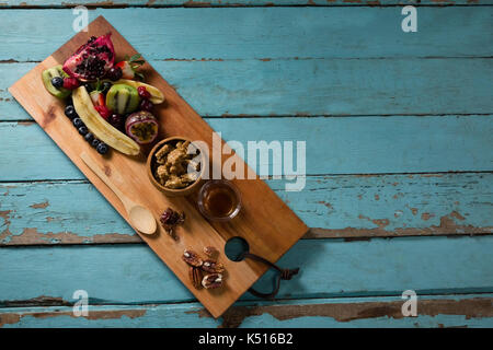 Slice of various fruits in tray on wooden table Stock Photo