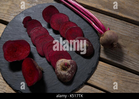 Close-up of slices of beetroots arranged on chopping board Stock Photo