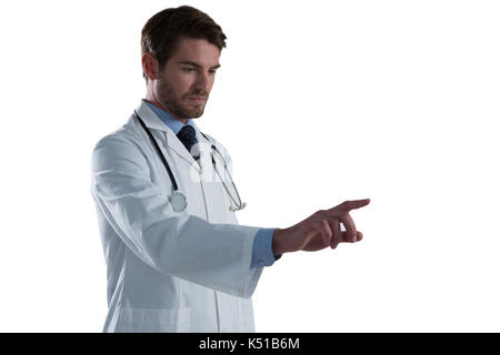 Male doctor using invisible screen against white background Stock Photo