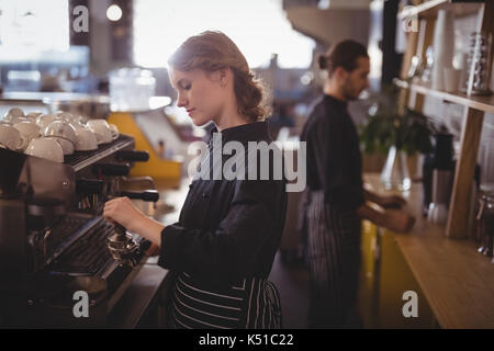 Side view of young baristas working at coffee shop Stock Photo
