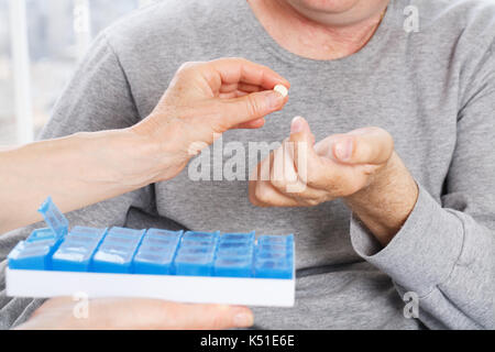 Hand gives a patient man the medicine Stock Photo