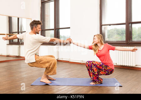 Man and woman practicing partner yoga Stock Photo