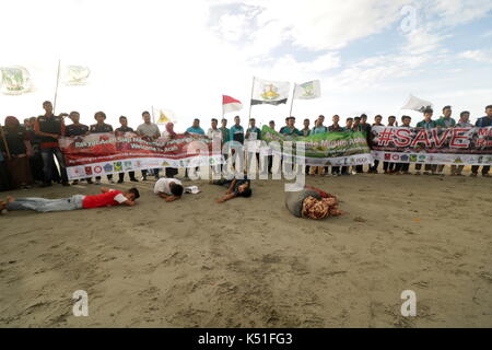 Banda Aceh, Indonesia. 07th Sep, 2017. Dozens of students in the province of Aceh, Indonesia, took a theatrical action to defend the Rohingya Muslim minority. In the action, students demonstrate Myanmar military violence against the Rohingya minority that causes them to flee to other countries. Theatrical action taking place on the seafront describes Rohingya refugees who were stranded in Aceh by mid 2015. They were rescued by Acehnese fishermen after being oscillated in the sea after an escape from their country. Credit: Abdul Hadi Firsawan/Pacific Press/Alamy Live News Stock Photo