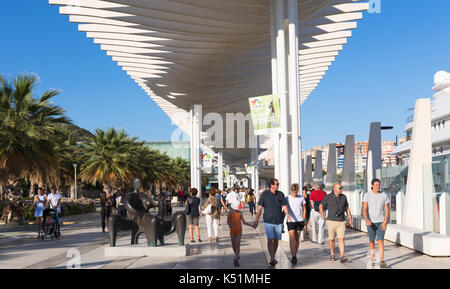 Malaga, Costa del Sol, Malaga Province, Andalusia, southern Spain.  People strolling beneath the Paseo de la Pergola on Muelle Uno. Stock Photo