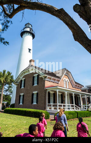 Georgia,St. Simons Island,St. Simons Island Light,lighthouse,keeper's house,exterior,woman female women,boy,girl,school children,student,field trip,US Stock Photo