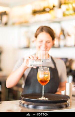A female bartender pouring a drink Stock Photo