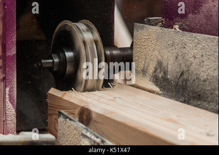 The machine for sampling the groove in a wooden beam with a milling cutter for vertical grooving. another view Stock Photo