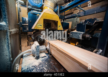 The machine for sampling the groove in a wooden beam. in progress from afar Stock Photo