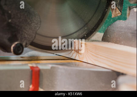 Circular saw with a wooden beam and measuring scale. Sawing a wooden beam with a circular saw. one more view Stock Photo