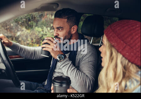 https://l450v.alamy.com/450v/k522gr/young-man-and-woman-traveling-by-car-and-having-coffee-couple-drinking-k522gr.jpg