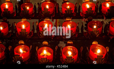 Prayer candles burning in a Roman Catholic church in Savannah, Georgia, close up Stock Photo