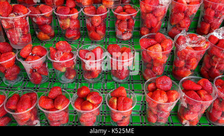 Cups of fresh red strawberries for sale at the Chatuchak Weekend Market in Bangkok, Thailand Stock Photo