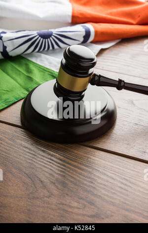 stock photo showing Indian low and jurisdiction - Indian national flag or tricolour with wooden gavel showing concept of law in India Stock Photo