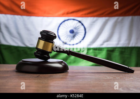 stock photo showing Indian low and jurisdiction - Indian national flag or tricolour with wooden gavel showing concept of law in India Stock Photo